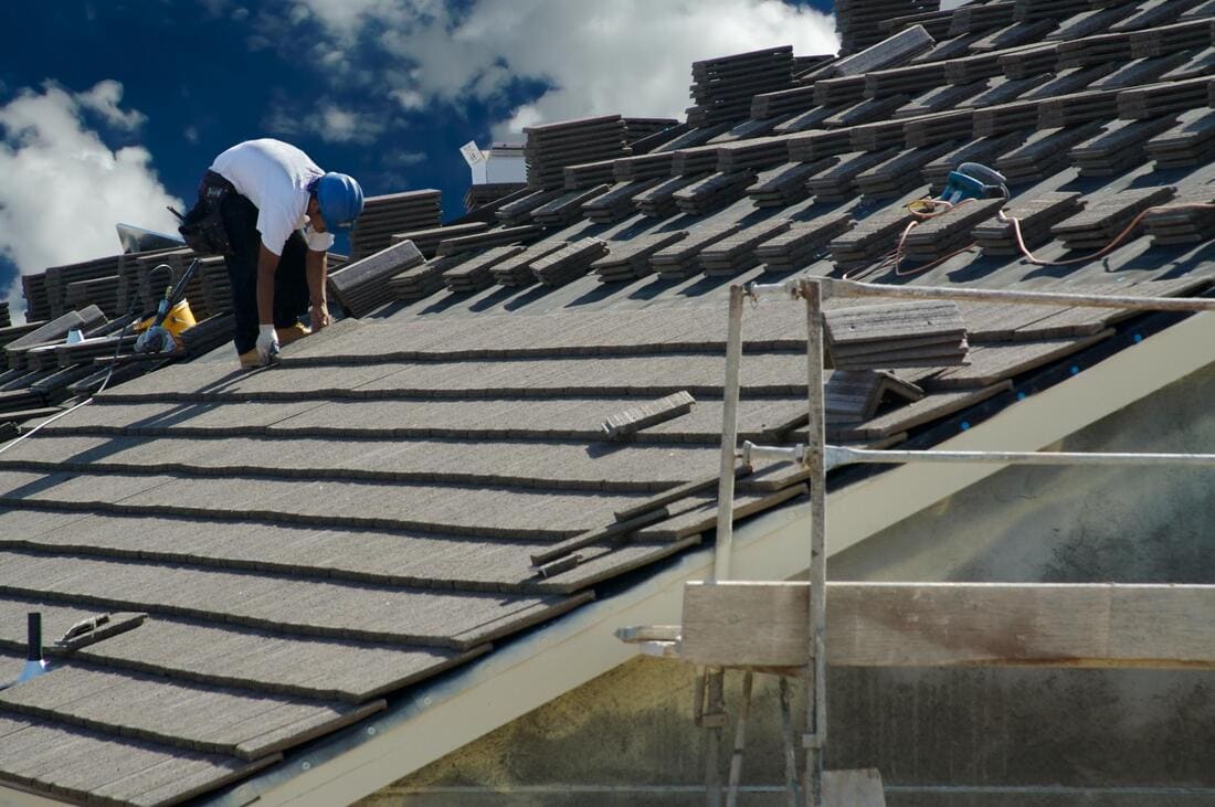 Roofers installing roofing over battens