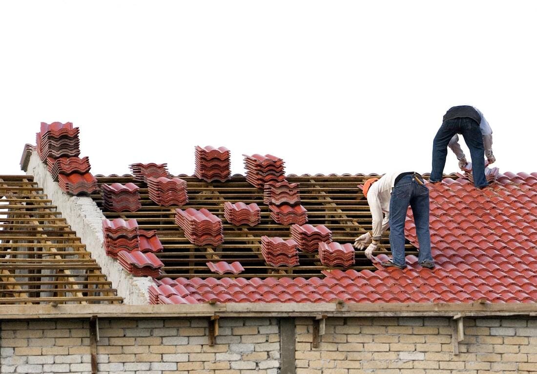 Crew re-roofing with new roofing material